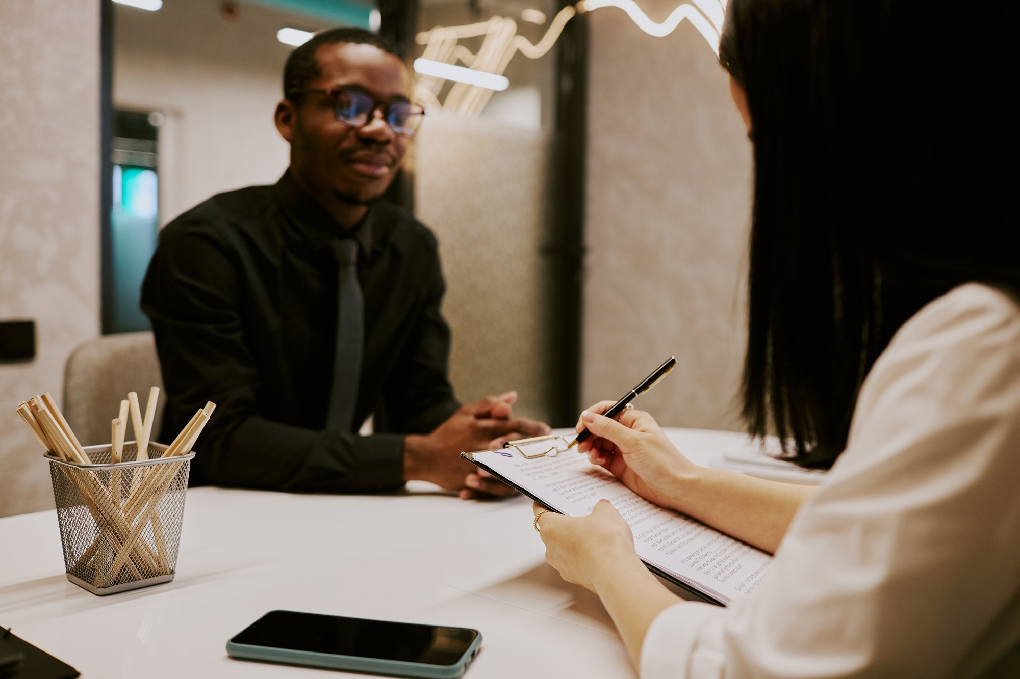Unrecognizable Employer Making Notes During Interview